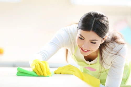 Office cleaning team sanitizing a modern reception area